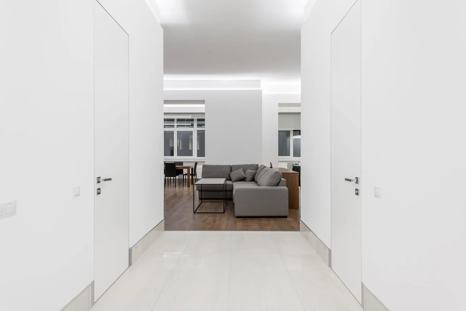 Living room with a gray sofa and light walls; illustrative photo